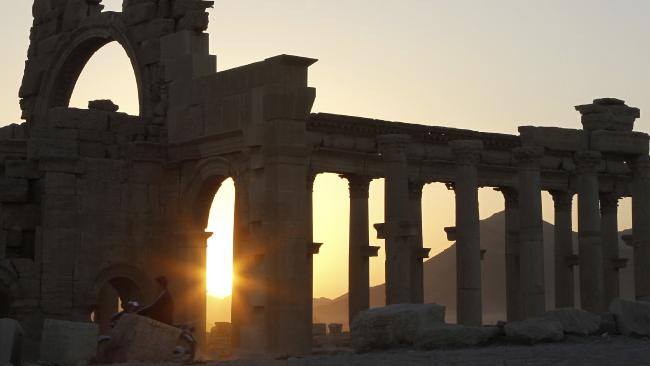 The sun sets behind ruined columns at the historical city of Palmyra. Picture: Khaled al-Hariri/Reuters